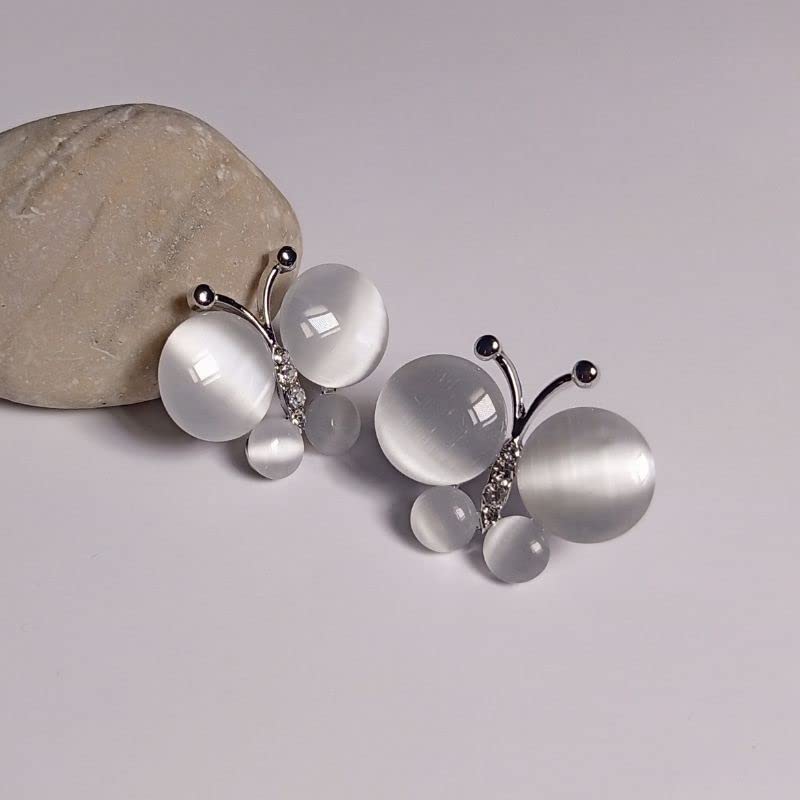 Jewelry piece with white stones and silver accents on a light gray background