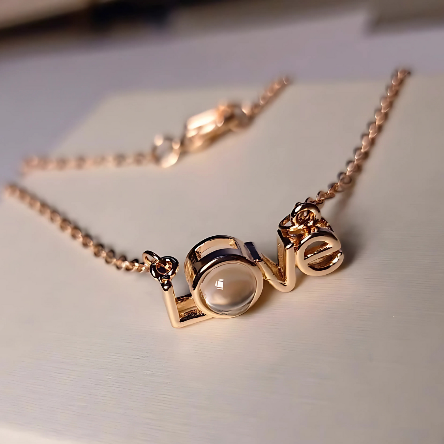 Rose gold necklace with a unique pendant on a light background