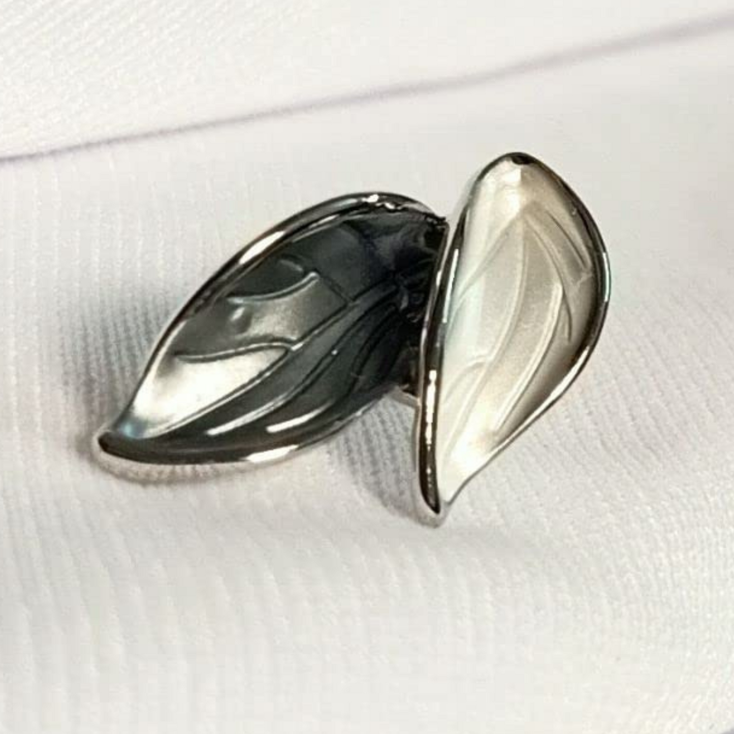 Silver leaf-shaped earring on a white background