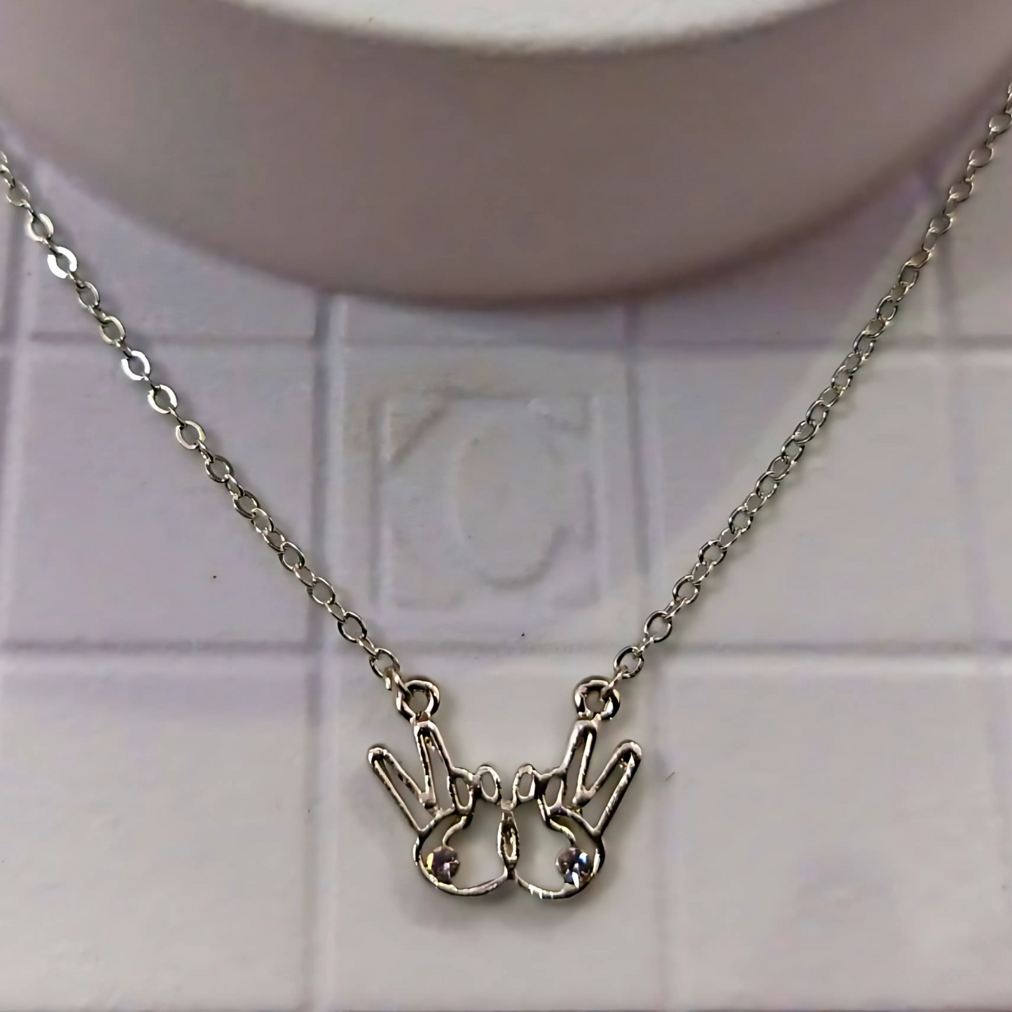 Necklace with a unique pendant on a tiled background