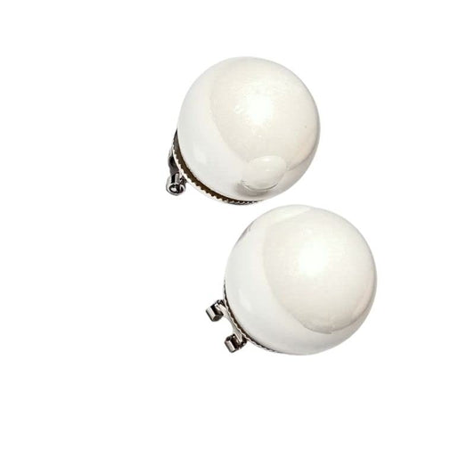 Pair of white pearl earrings on a white background