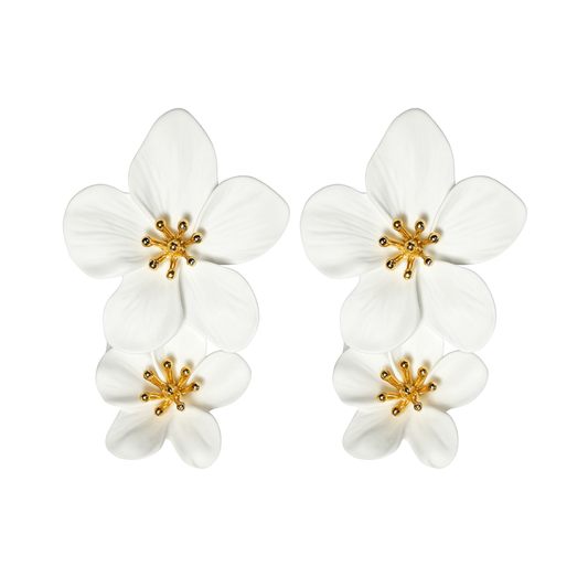 Pair of white flower-shaped earrings with gold centers on a white background
