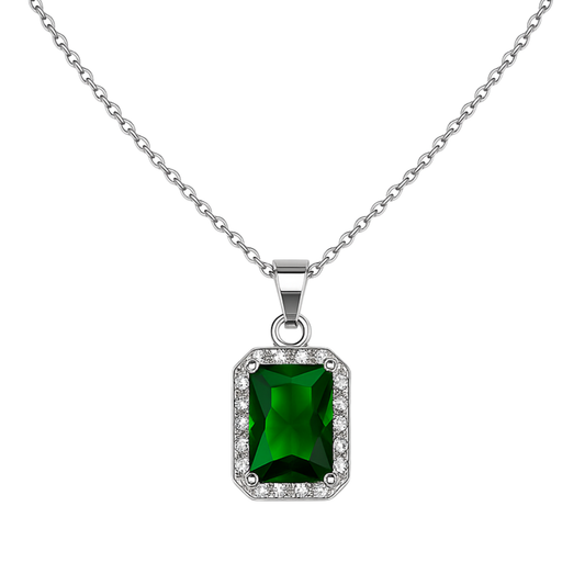 Green gemstone pendant with silver chain on a white background