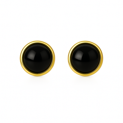 Pair of black round earrings with gold rims on a white background