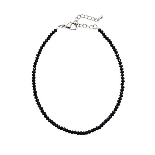 Black beaded necklace on a white background