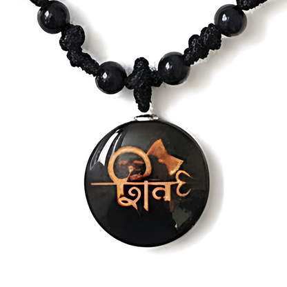 Black beaded necklace with a round pendant featuring a design and text on a white background