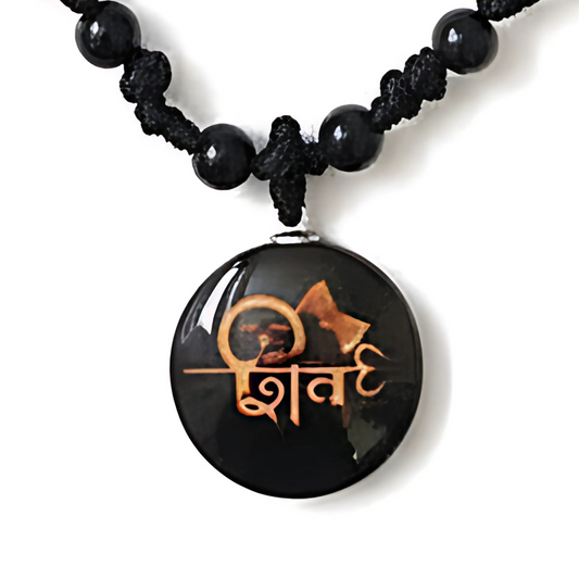 Black beaded necklace with a round pendant featuring a design and text on a white background