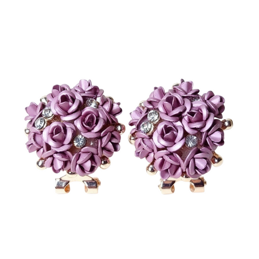 Pair of purple floral earrings with rose gold accents on a white background