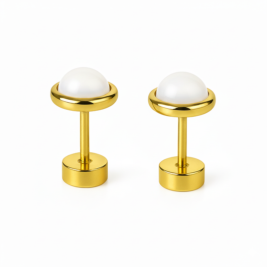 Pair of gold cufflinks with white spherical stones on a white background