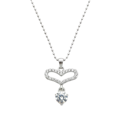 Silver necklace with a heart-shaped pendant on a white background