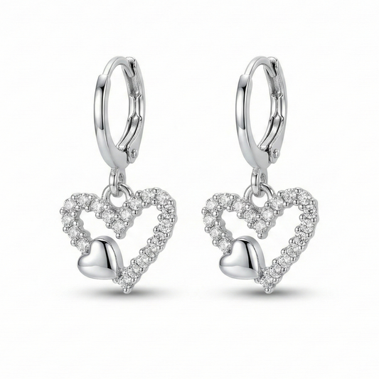 Silver heart-shaped earrings with clear stones on a white background