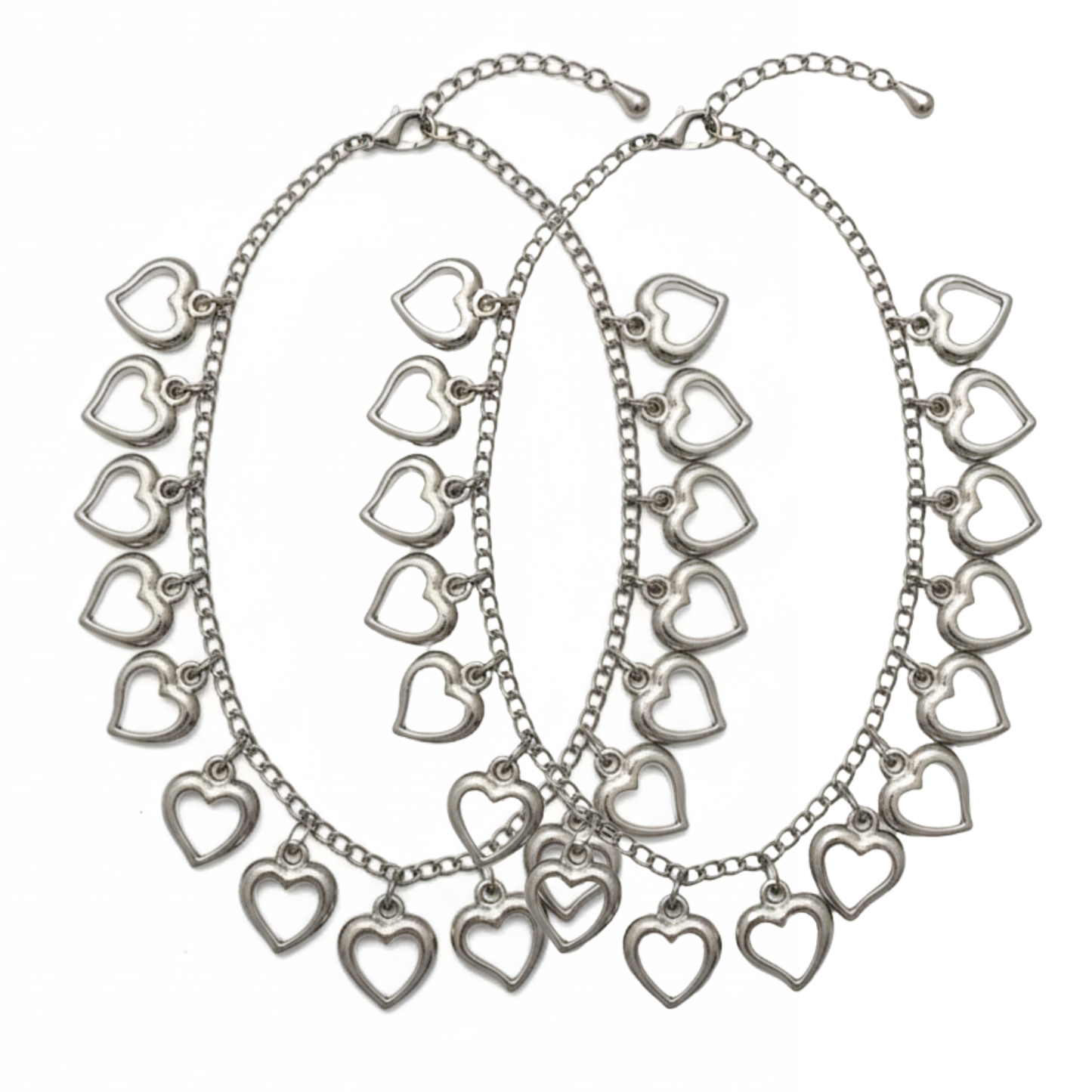 Silver heart-shaped charm necklaces on a white background