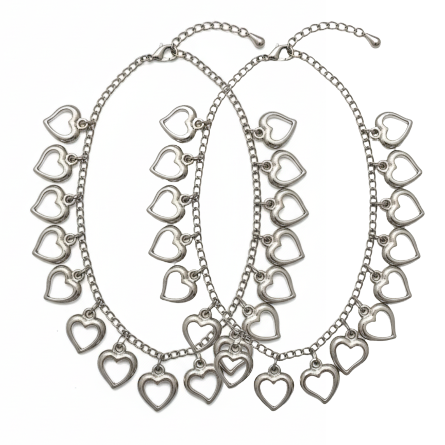 Silver heart-shaped charm necklaces on a white background