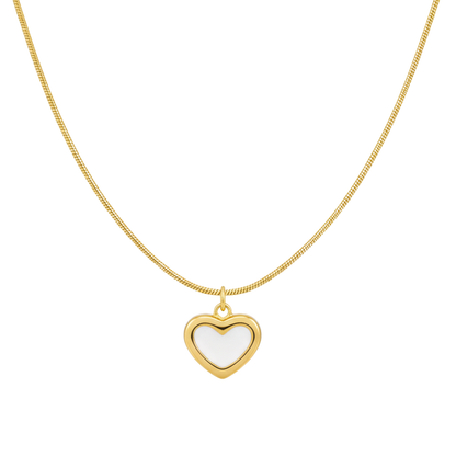Gold necklace with a heart-shaped pendant on a white background