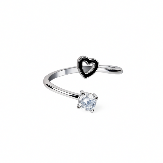 Silver ring with heart-shaped bezel and clear gemstone on a white background