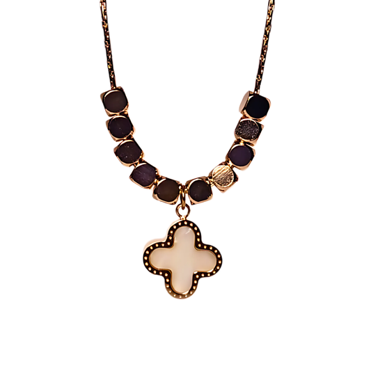 Necklace with gold beads and a gold cross pendant on a white background