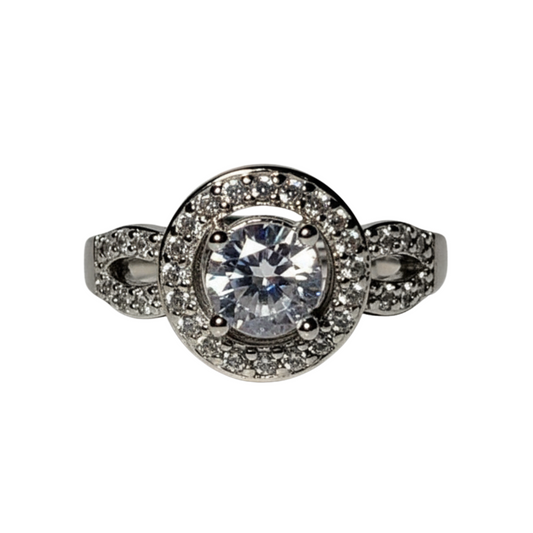 Silver ring with a large central gemstone and smaller stones on a white background