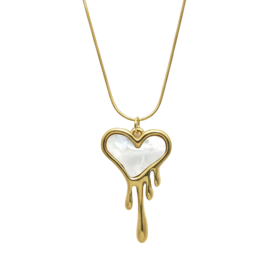 Heart-shaped pendant with gold drip design on a white background