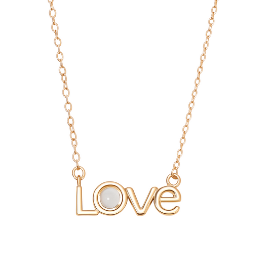Gold necklace with 'LOVE' pendant on a white background