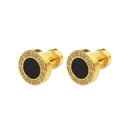 Gold cufflinks with black center on a white background