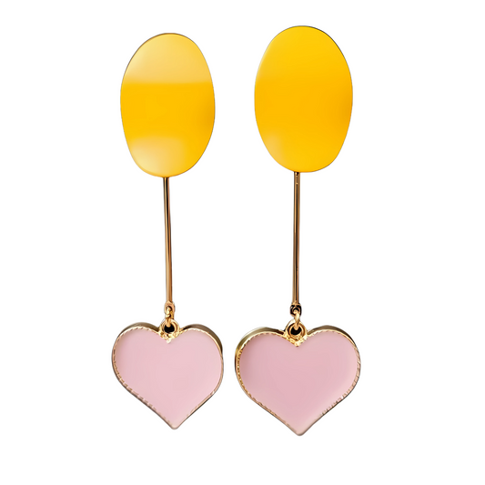Pair of earrings with yellow oval tops and pink heart bottoms on a white background
