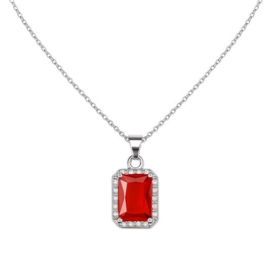 Silver necklace with a red gemstone pendant on a white background