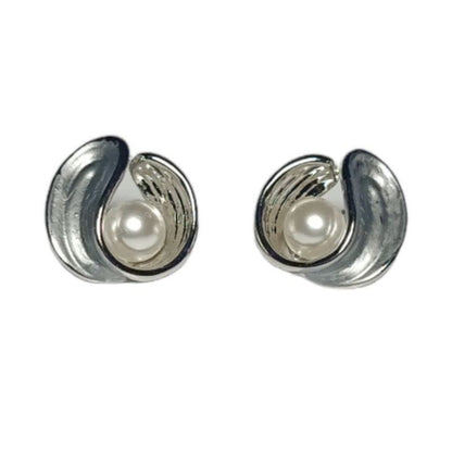 Pair of silver earrings with pearl centers on a white background