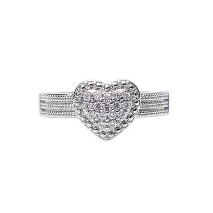 Silver heart-shaped ring with embedded stones on a white background