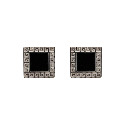 Pair of square earrings with black centers and decorative silver borders on a white background