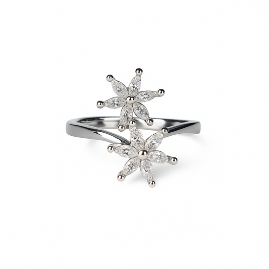 Silver ring with floral designs on a white background