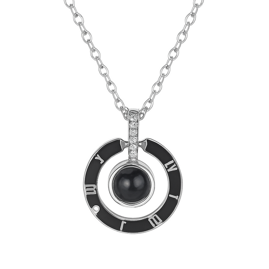 Necklace with a black pendant and Roman numeral design on a white background