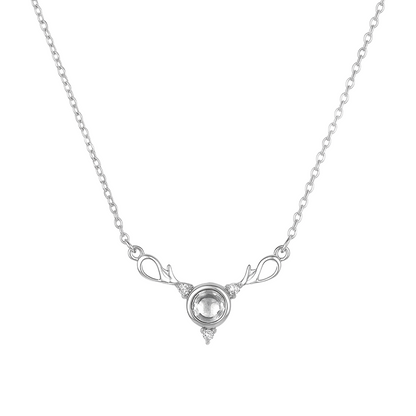 Silver necklace with a clear gemstone on a white background
