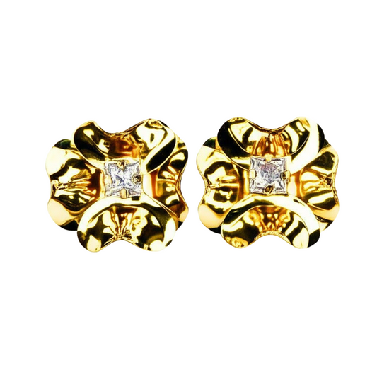 Pair of gold earrings with diamond-like stones on a white background