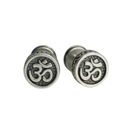 Pair of silver Om symbol earrings on a white background