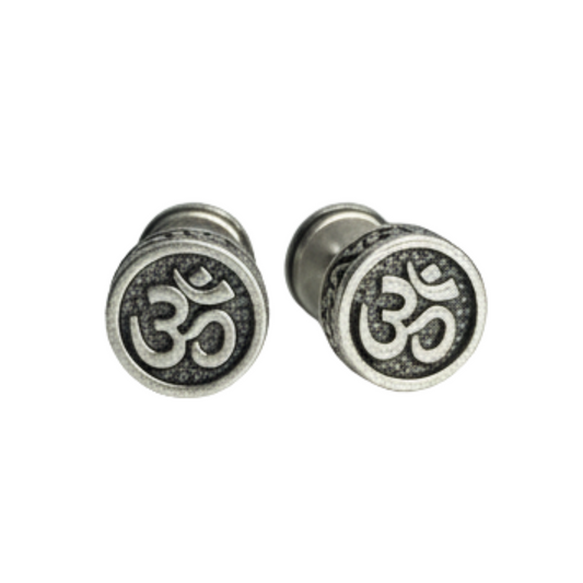 Pair of silver Om symbol earrings on a white background