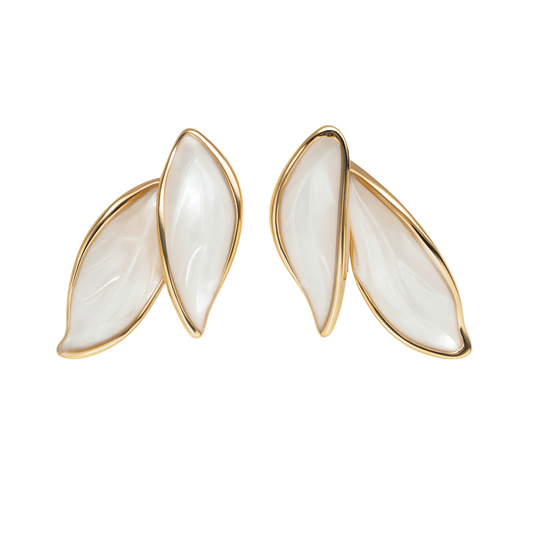 Pair of earrings with gold frames and white stones on a white background