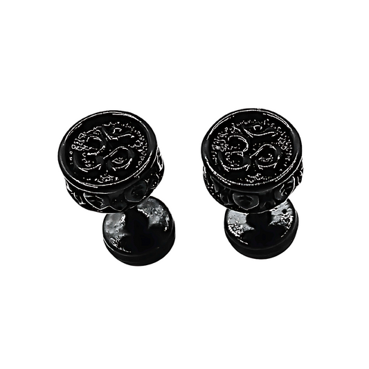 Pair of black om decorative knobs on a white background