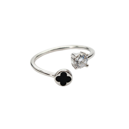 Silver ring with black clover and diamond on a white background
