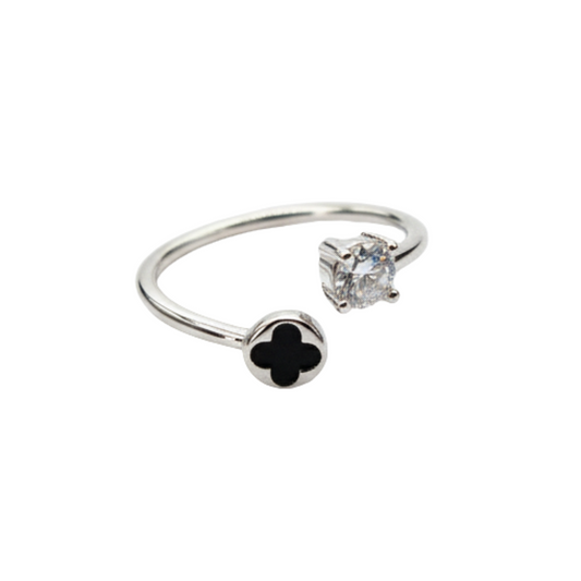 Silver ring with black clover and diamond on a white background