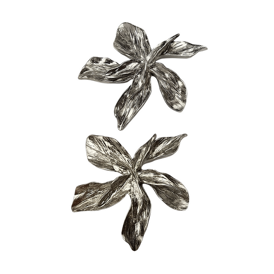 Pair of silver leaf-shaped earrings on a white background