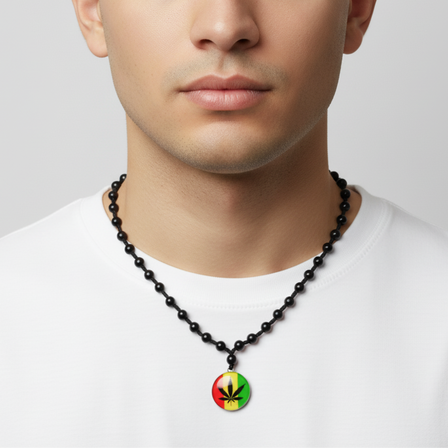 Man wearing a black beaded necklace with a colorful pendant on a white background