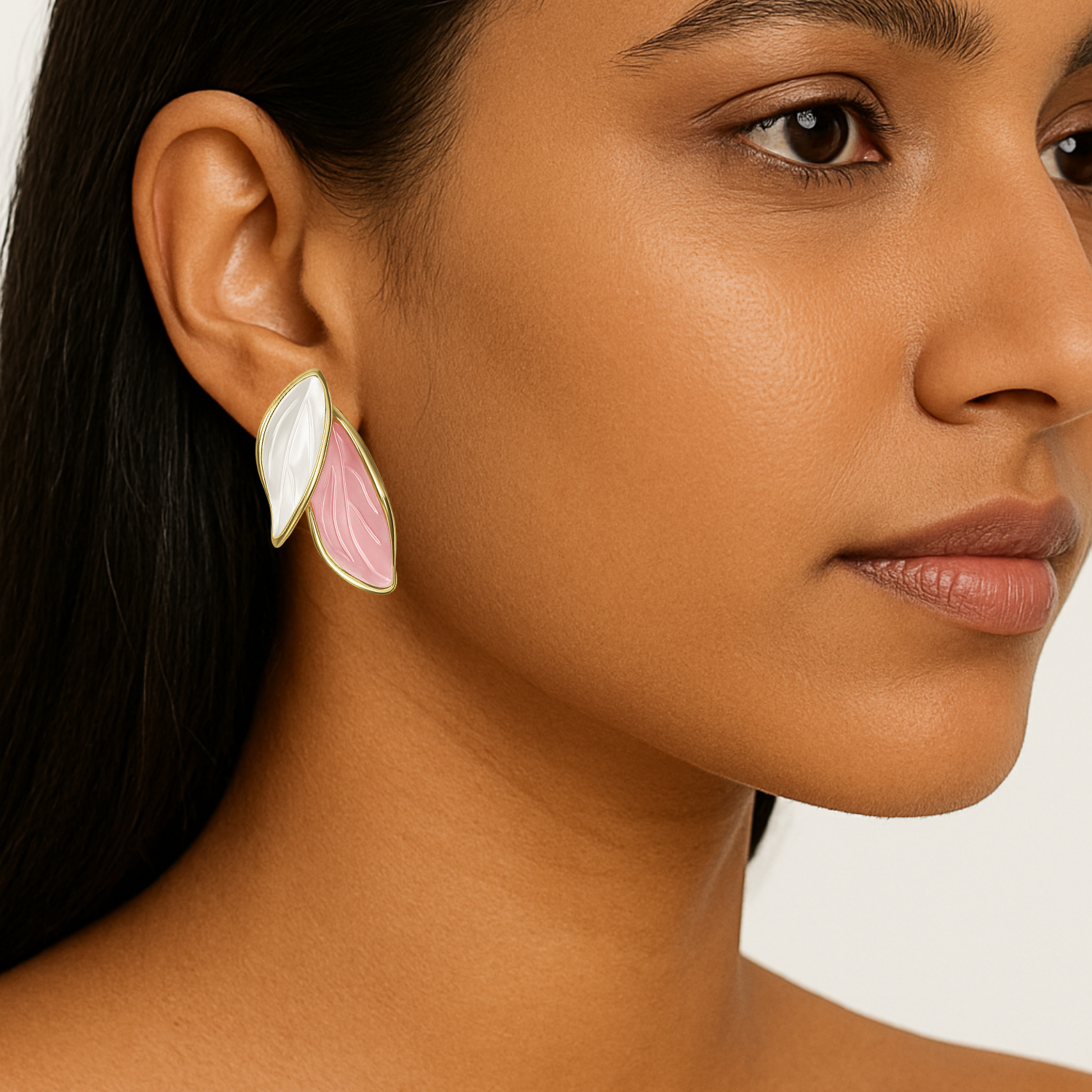 Close-up of a woman wearing a floral earring with a white and pink design.