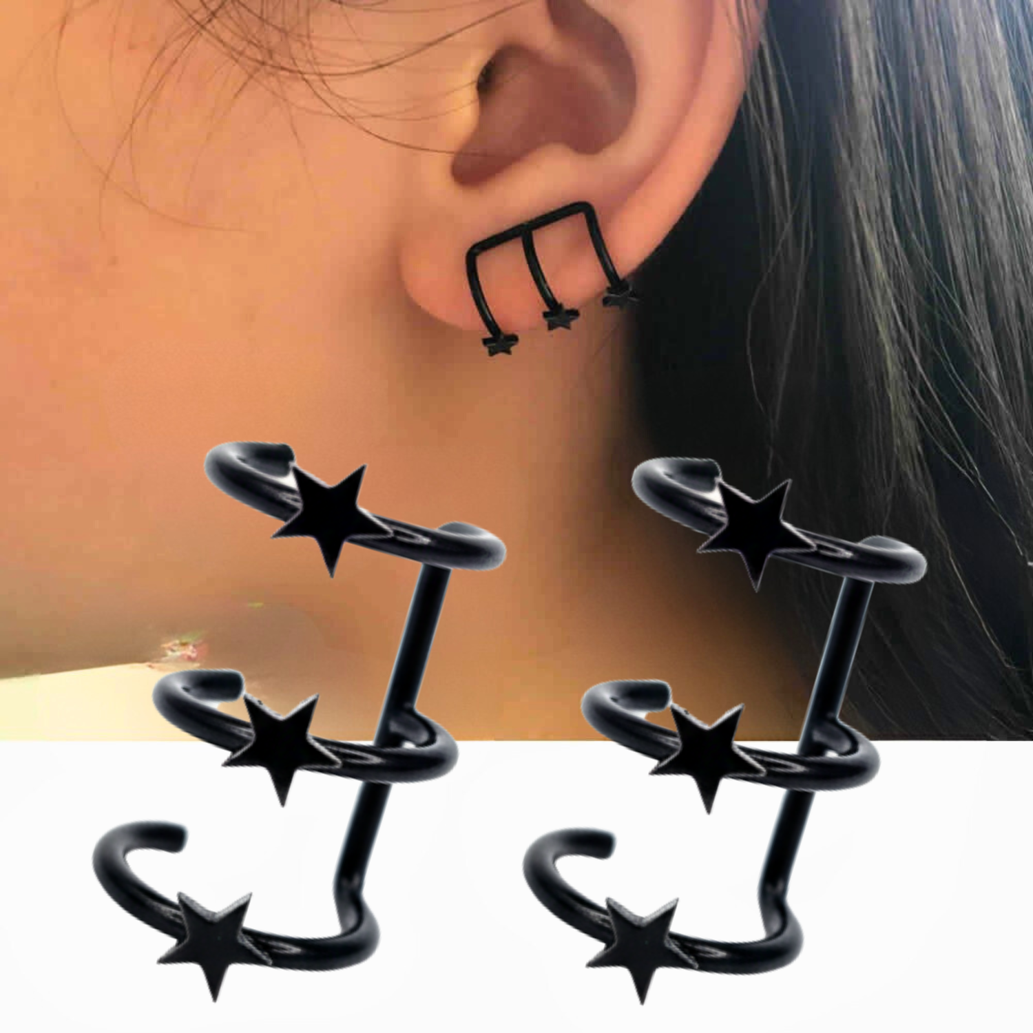 Black star-shaped earrings worn on an ear with a neutral background