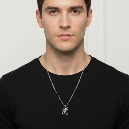 Man wearing a black shirt with a silver necklace featuring a symbol on a white background