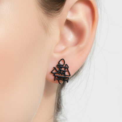 Black earrings worn by a person with a neutral background