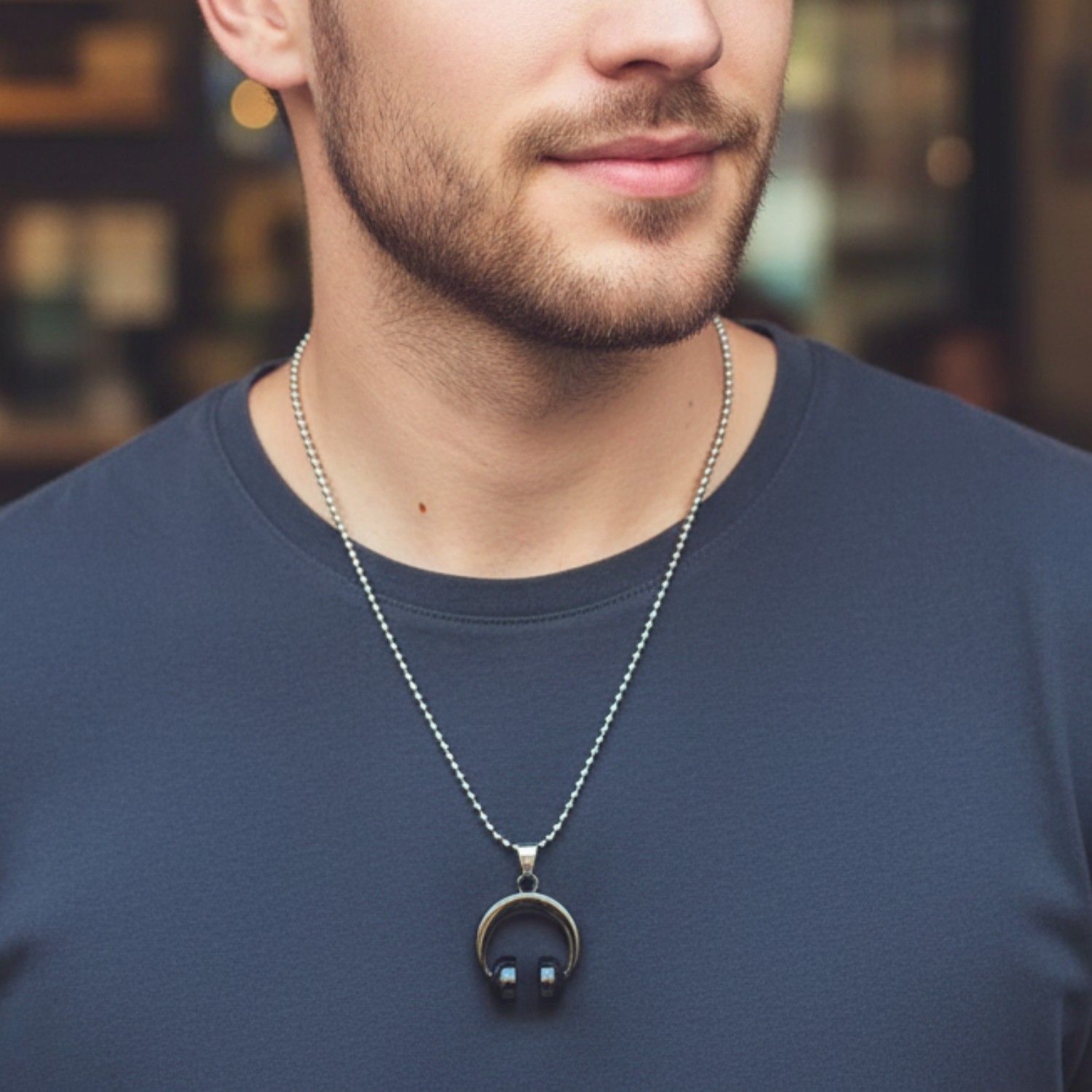 Man wearing a necklace with a pendant in an urban setting