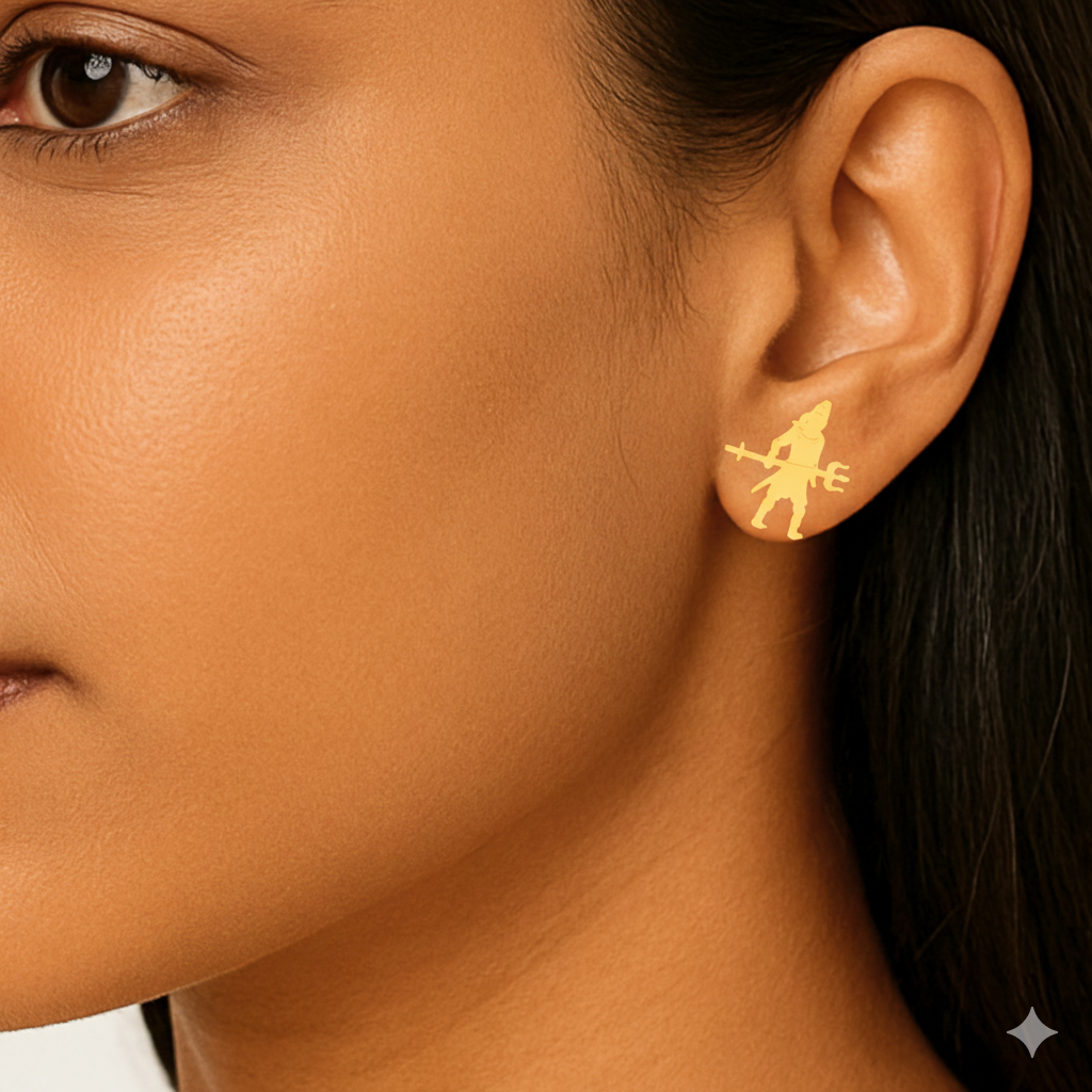 Close-up of a person wearing gold earrings with a star design.