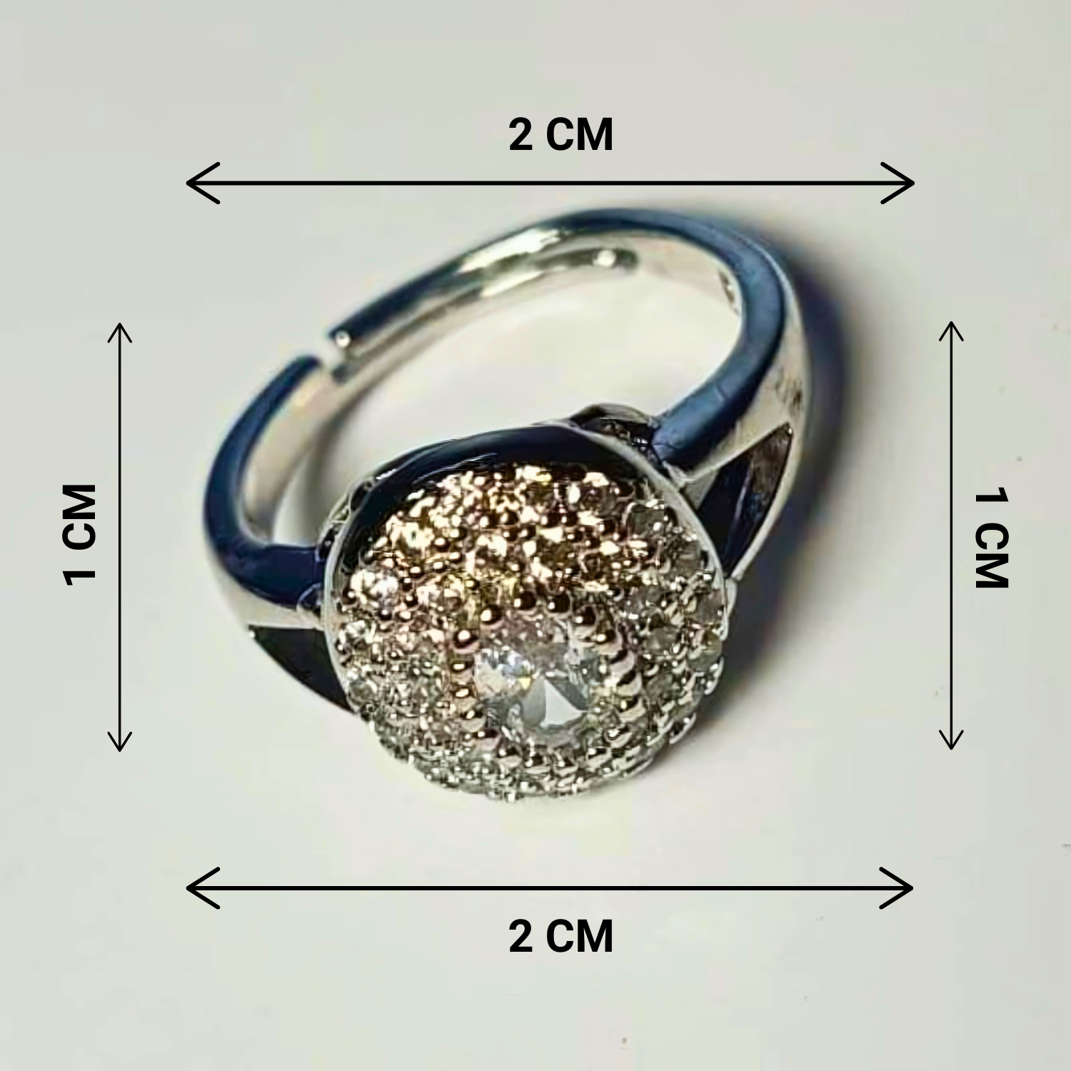 Silver ring with a diamond, shown with dimensions on a white background