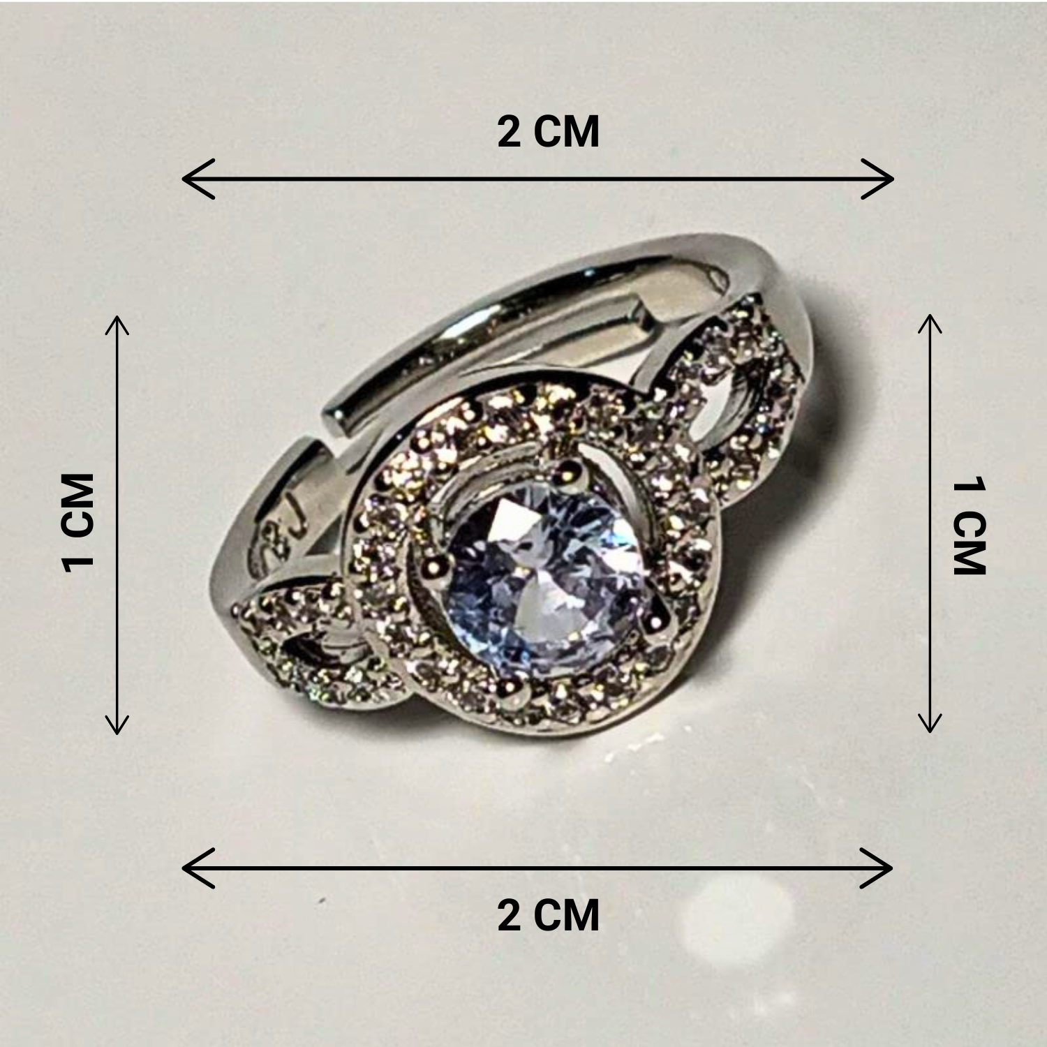 Silver ring with a large central gemstone, shown with dimensions on a light gray background.
