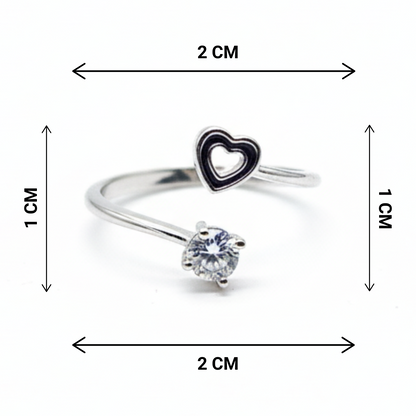 Silver ring with heart-shaped pendant and diamond, shown with measurements on a white background
